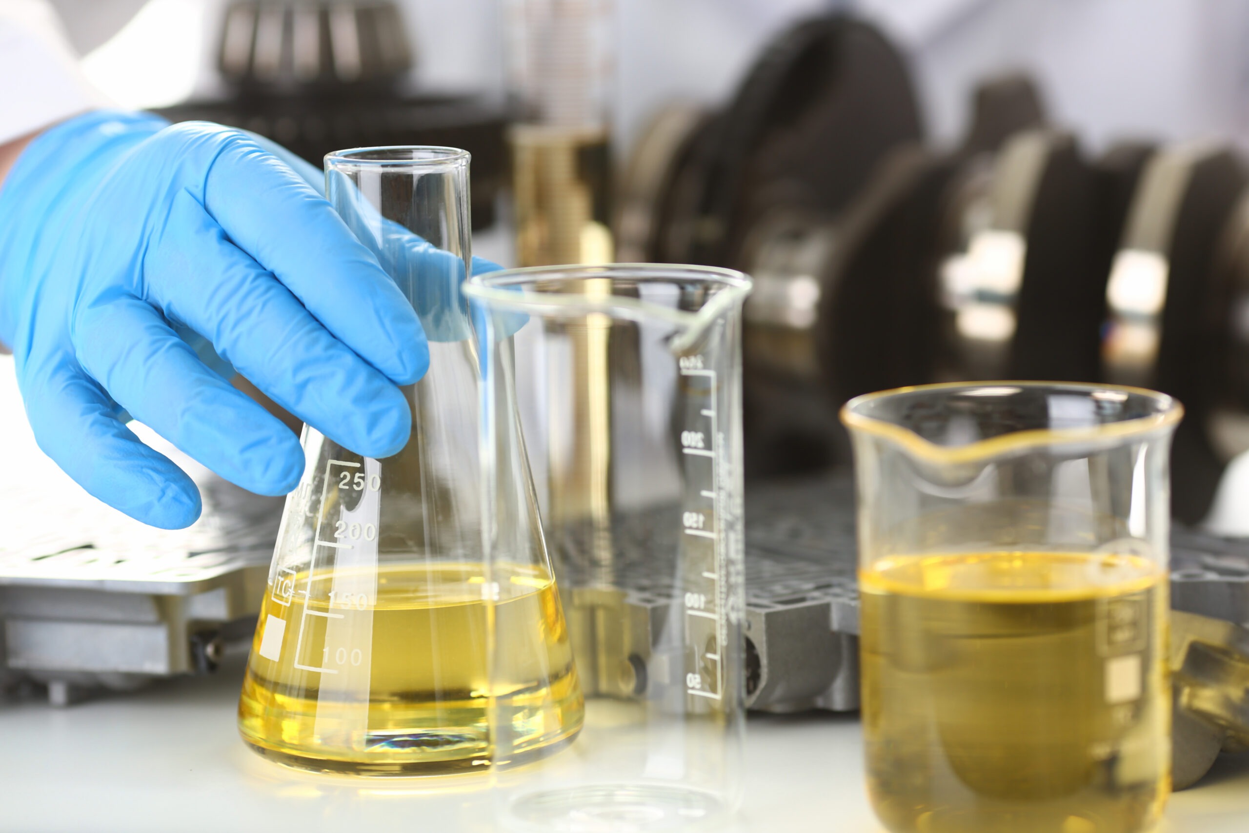 Male Hands In Protective Gloves Hold Test Tube In Hands